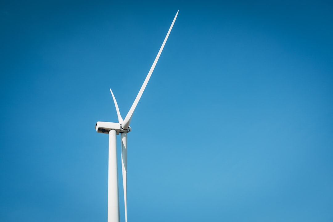 a wind turbine is shown against a blue sky, Wind Turbine, eastern Colorado