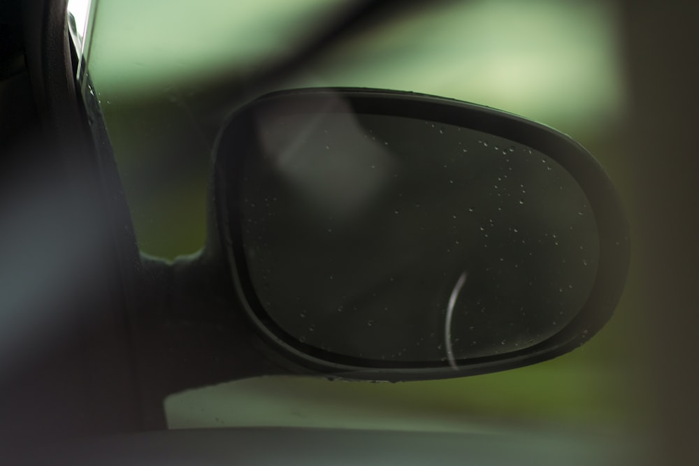 a side view mirror on a car with a blurry background