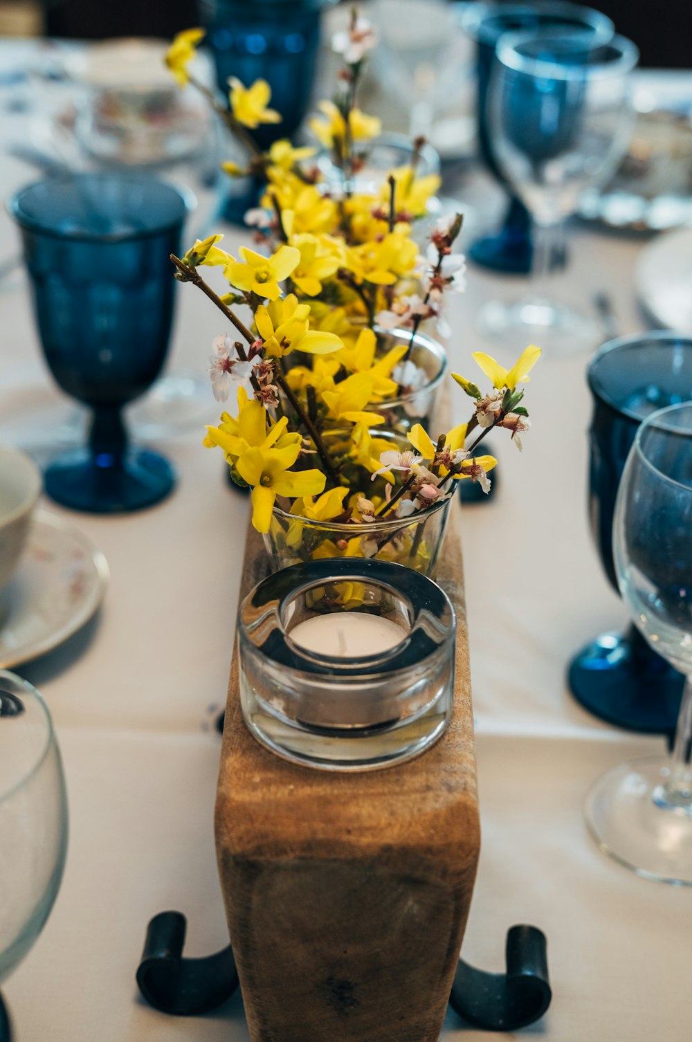 a vase with yellow flowers on a table