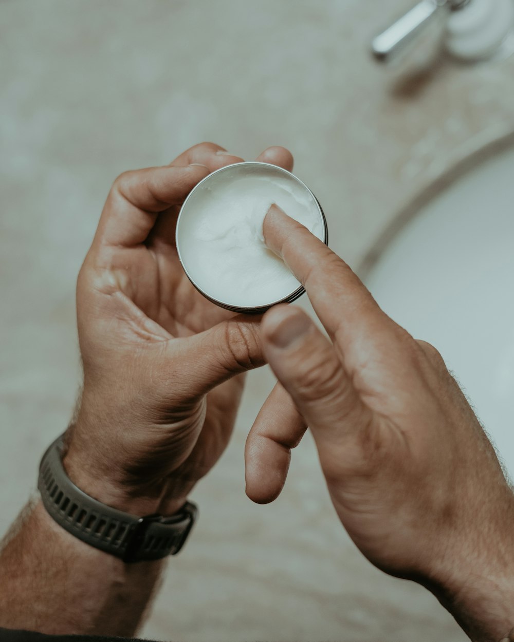 a man holding a bowl of cream in his hand