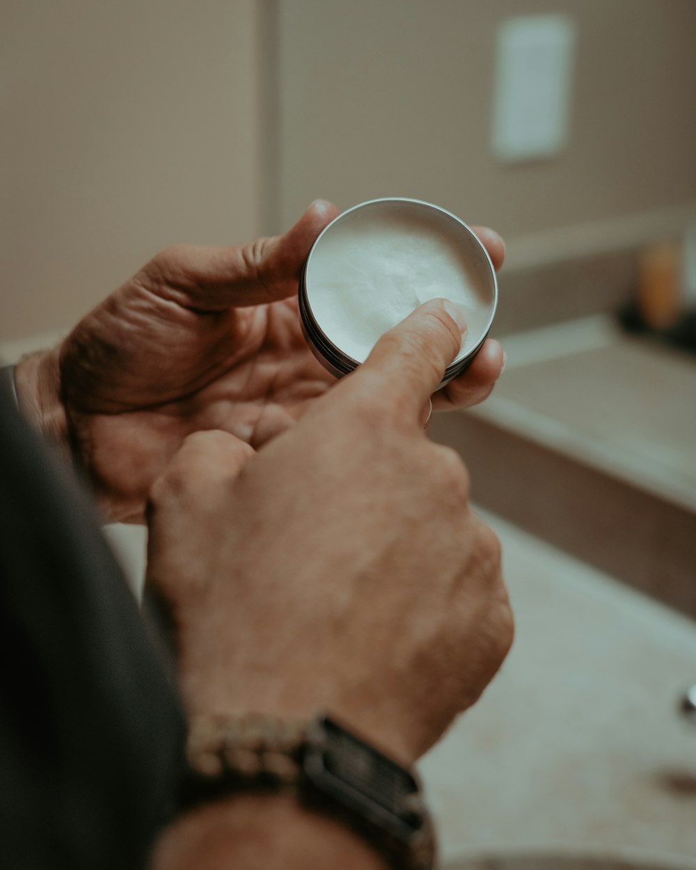 a man holding a glass of milk in his hand