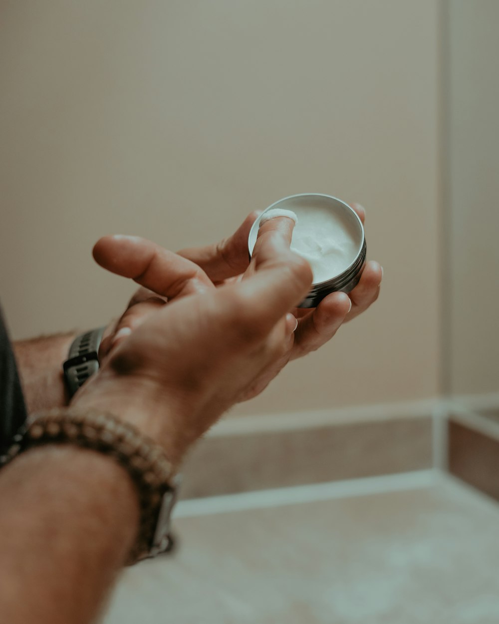 a person holding a bowl of cream in their hand