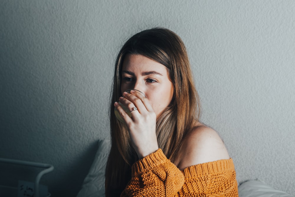 a woman covers her mouth with her hand