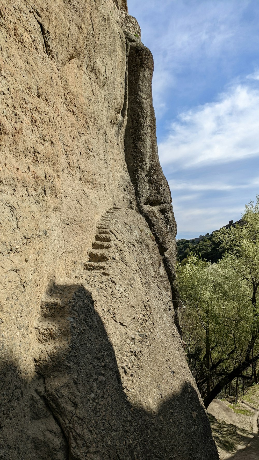 a man climbing up the side of a mountain