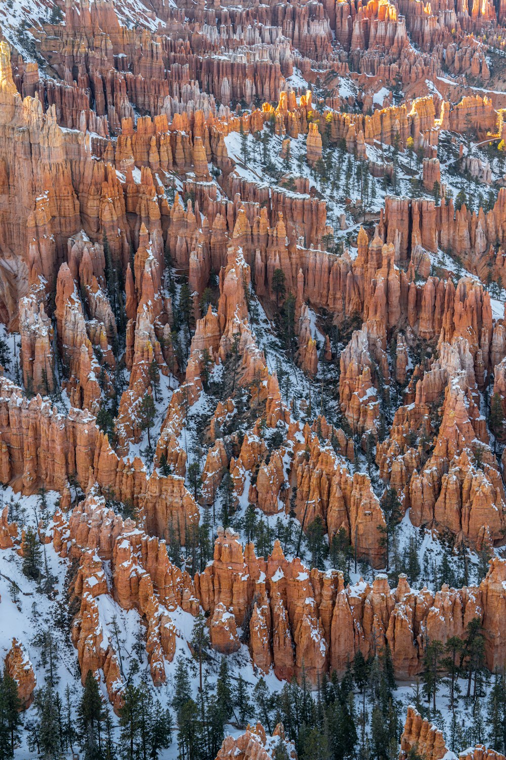 an aerial view of a snow covered mountain range