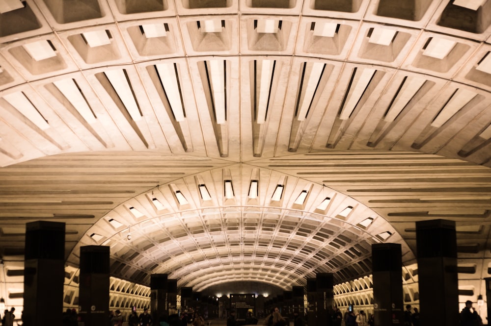 a train station with people walking through it