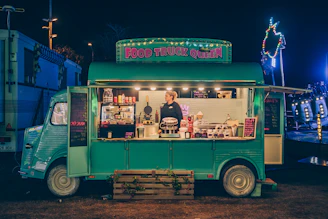 a food truck parked in a parking lot at night