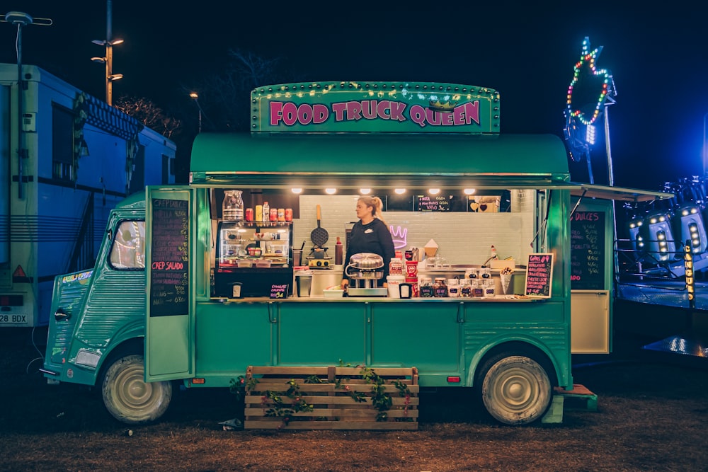 a food truck parked in a parking lot at night