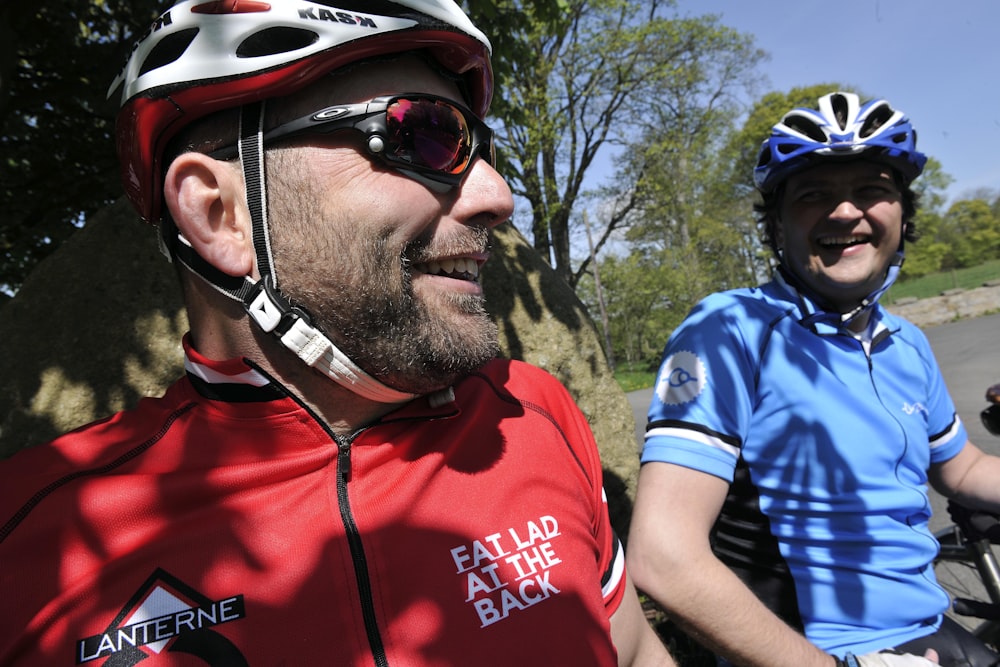 a man riding a bike next to another man on a bike