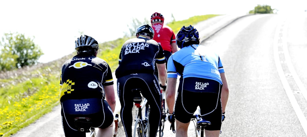 a group of people riding bikes down a road