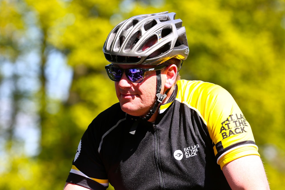 a man riding a bike wearing a helmet and sunglasses