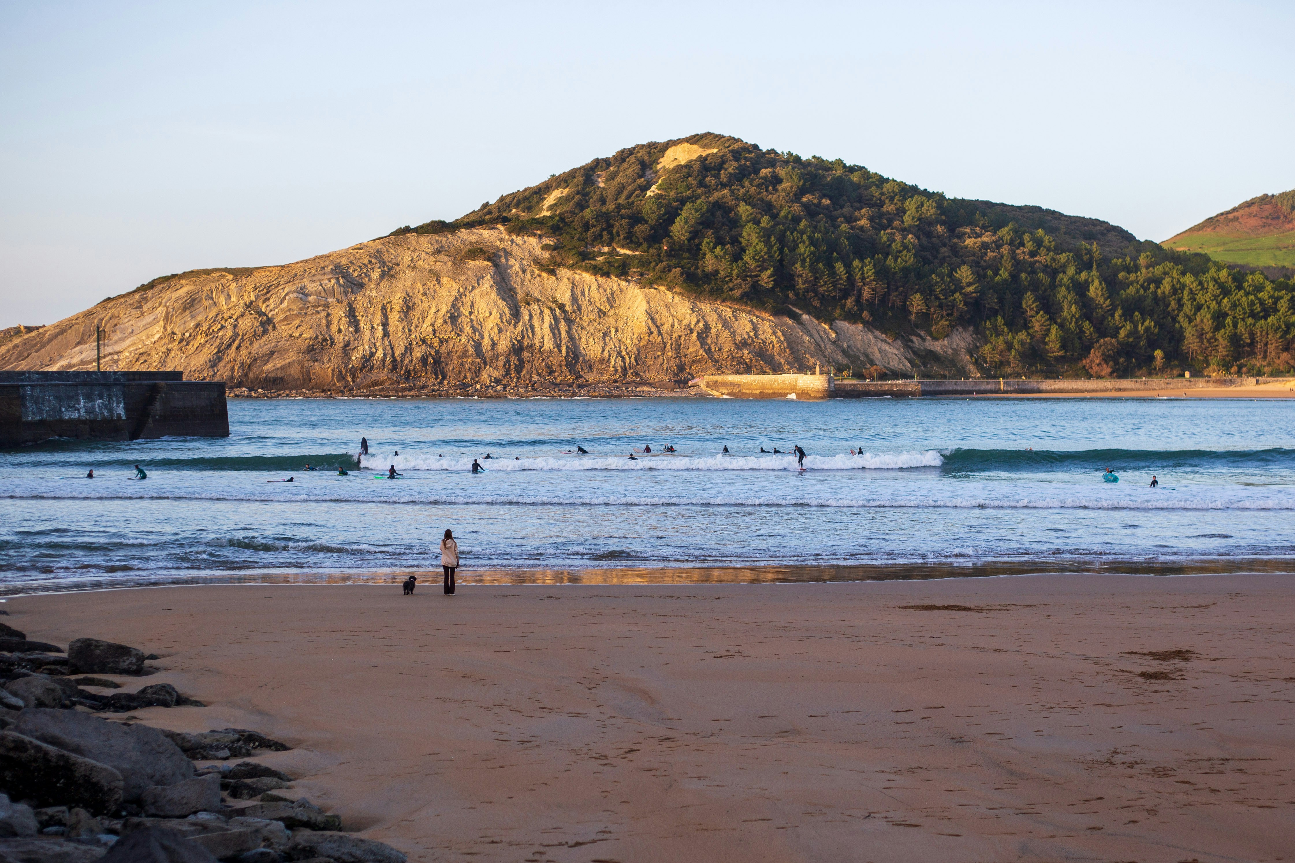 a group of people standing on top of a sandy beach