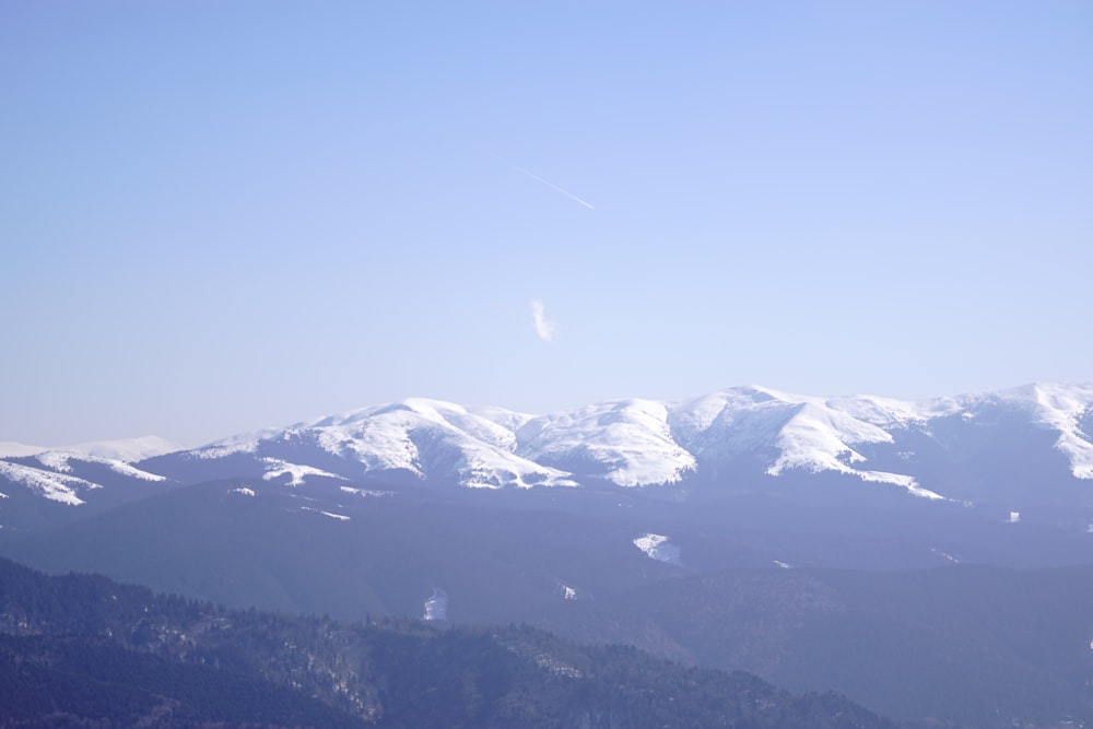 a view of a snowy mountain range from a distance