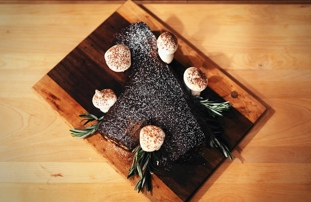 a wooden cutting board topped with a piece of cake