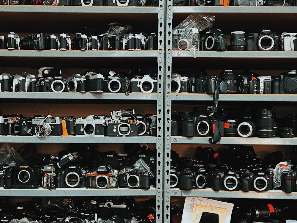 a bunch of cameras that are on a shelf