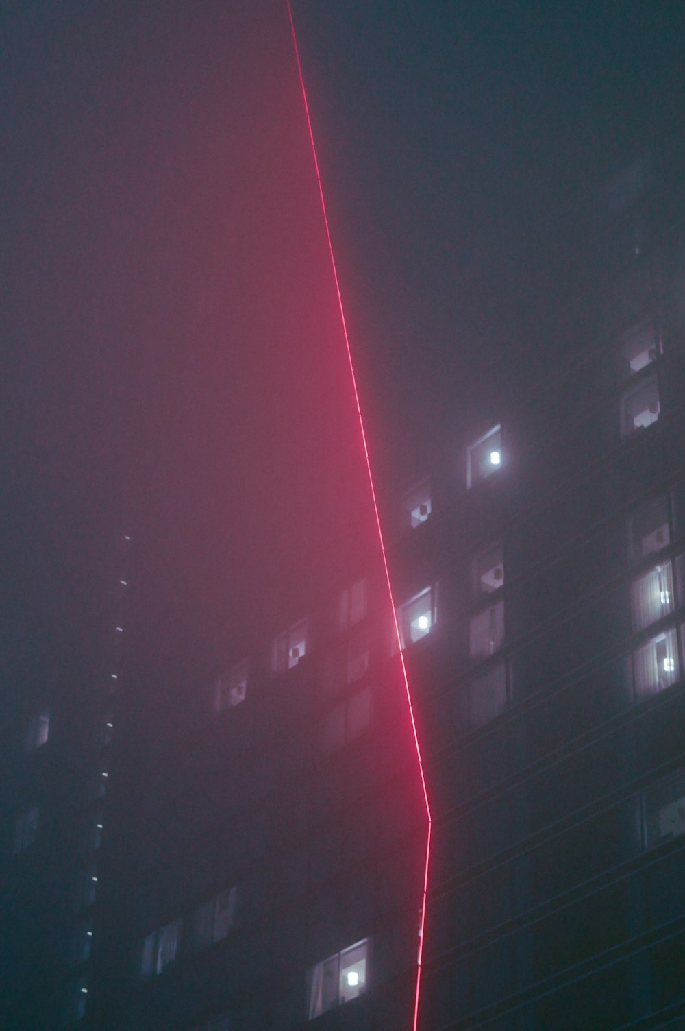 a tall building with a red light in the middle of it