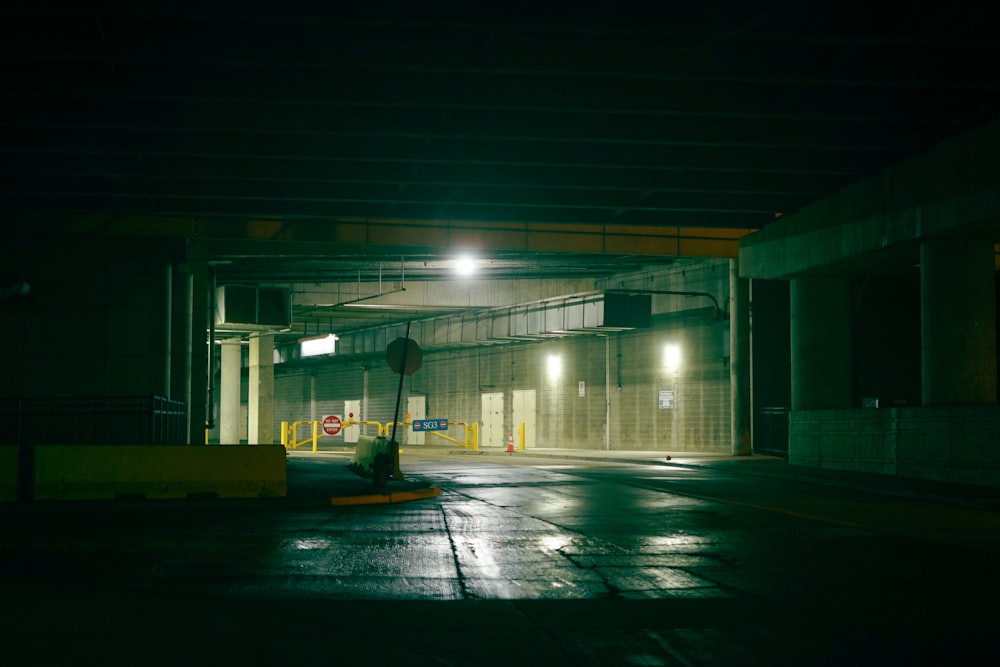 an empty parking garage at night with lights on