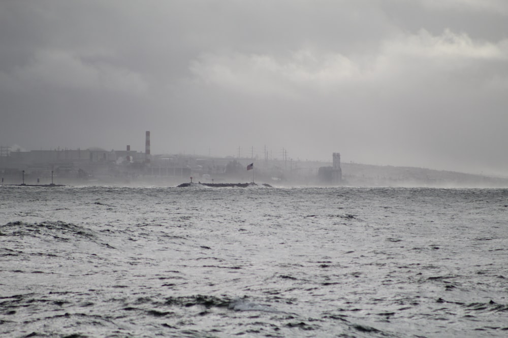 a large body of water with a city in the background