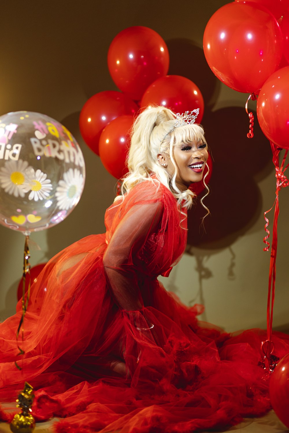 a woman in a red dress and balloons