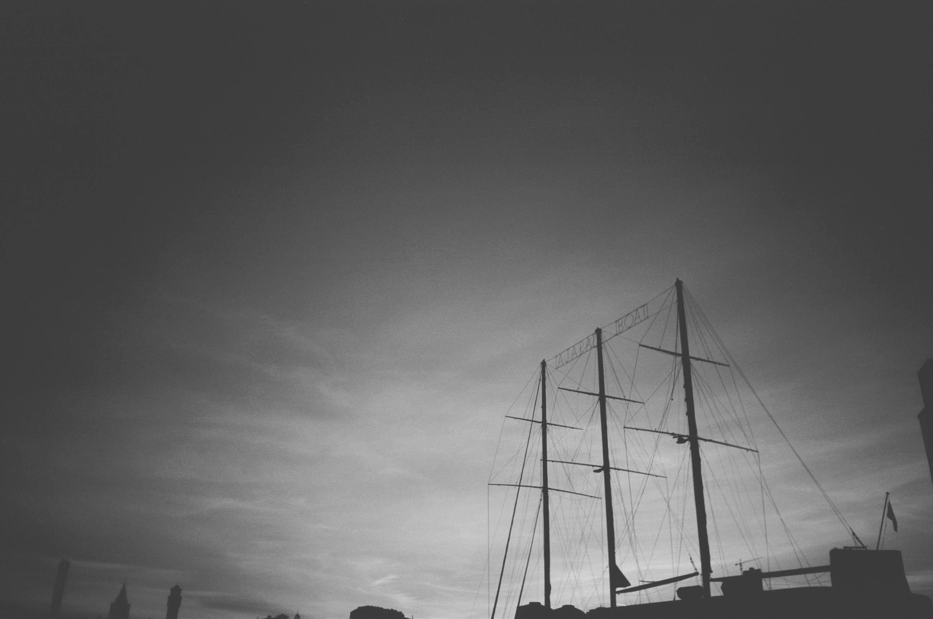 a black and white photo of a boat in the water