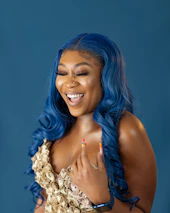 A smiling woman applying éclatnail press-on nails, radiating confidence and style.