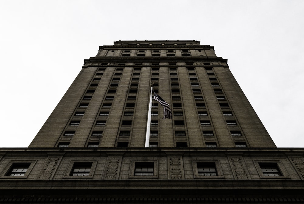 a tall building with a flag on top of it