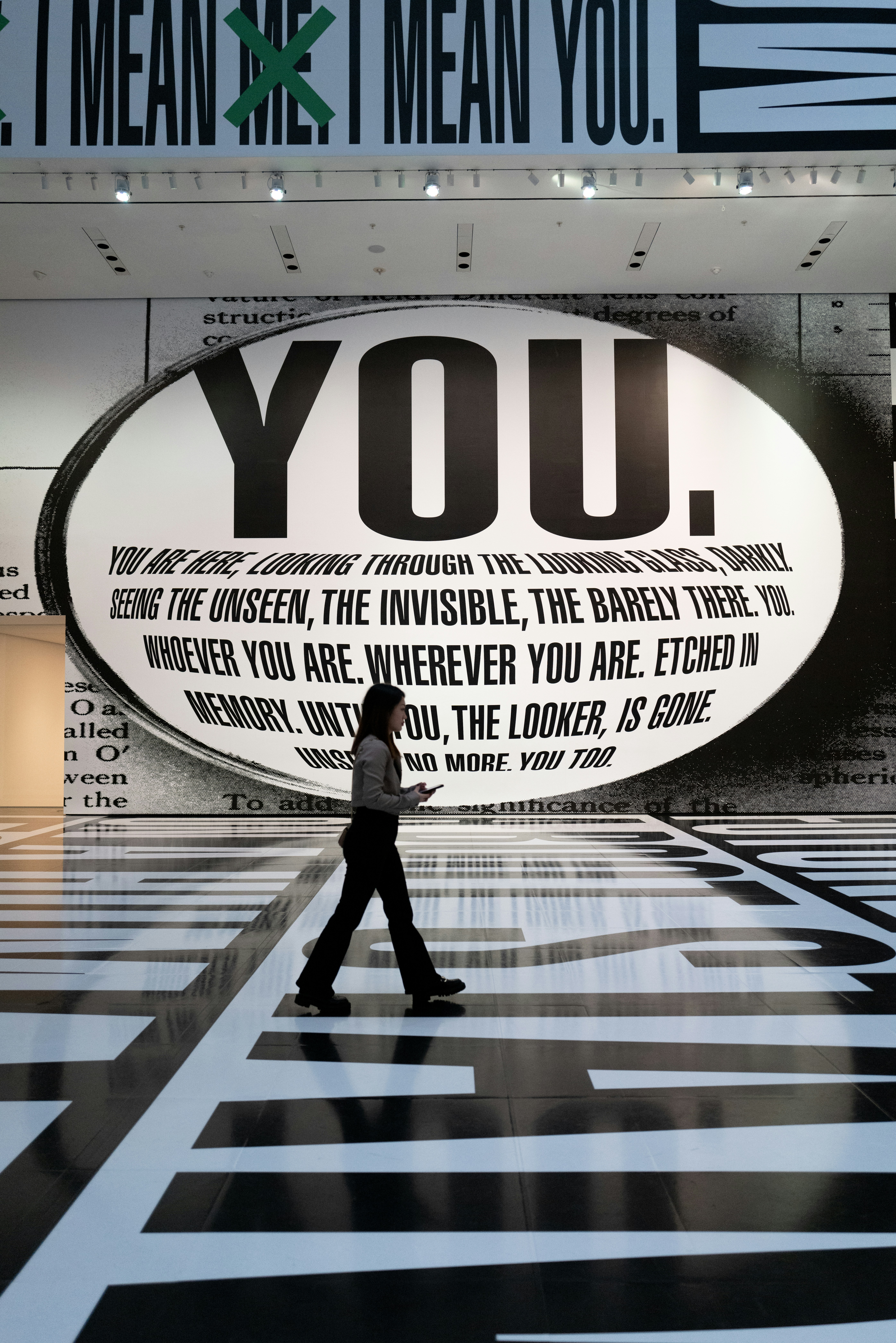 a person walking in front of a large advertisement