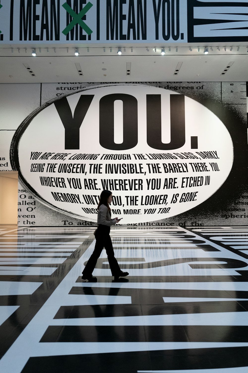 a person walking in front of a large advertisement