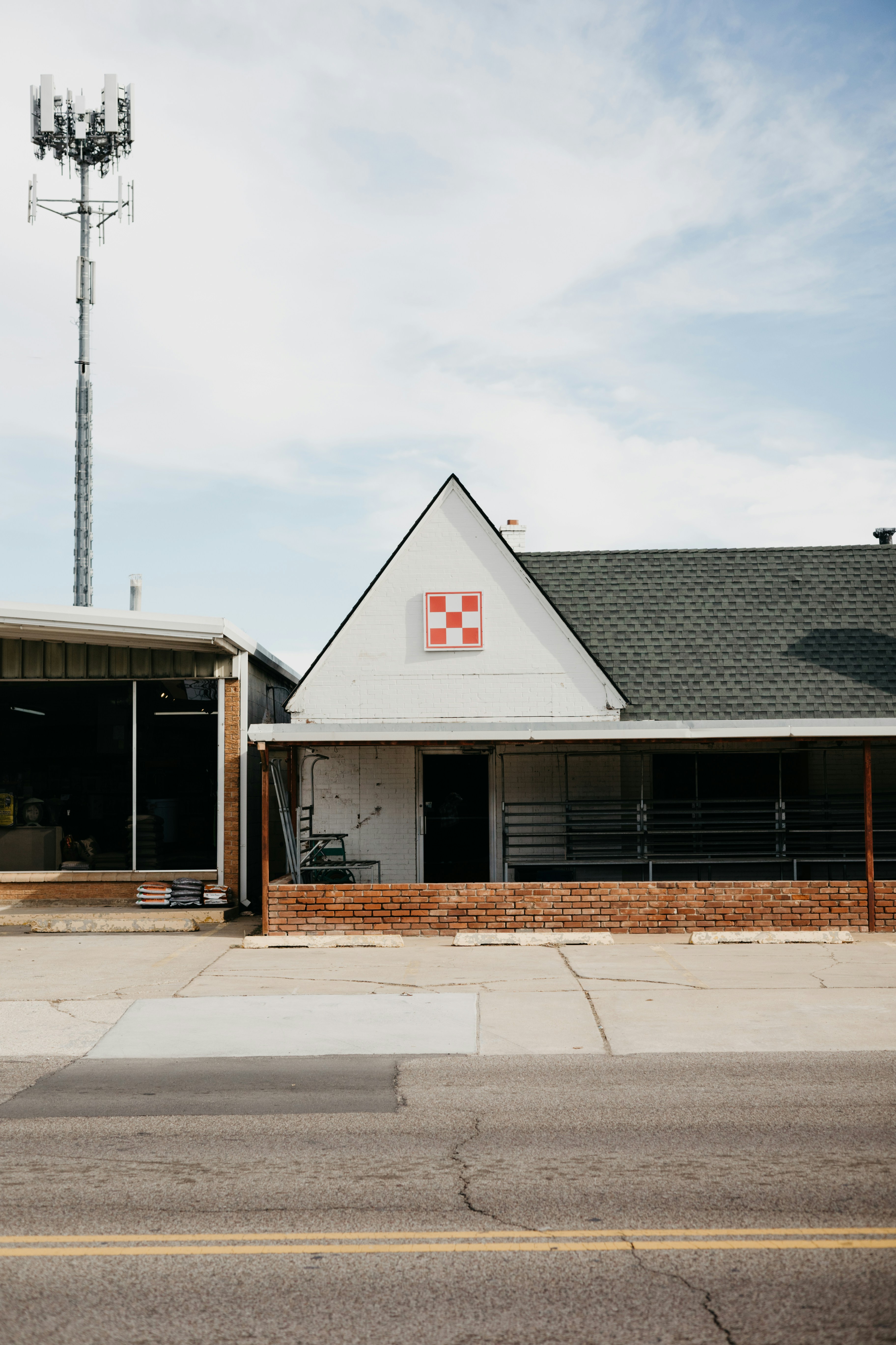 a white building with a red and white checkered flag