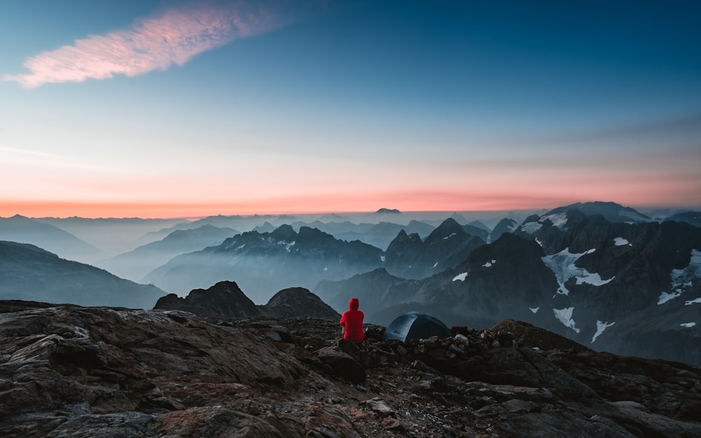 a person sitting on top of a mountain