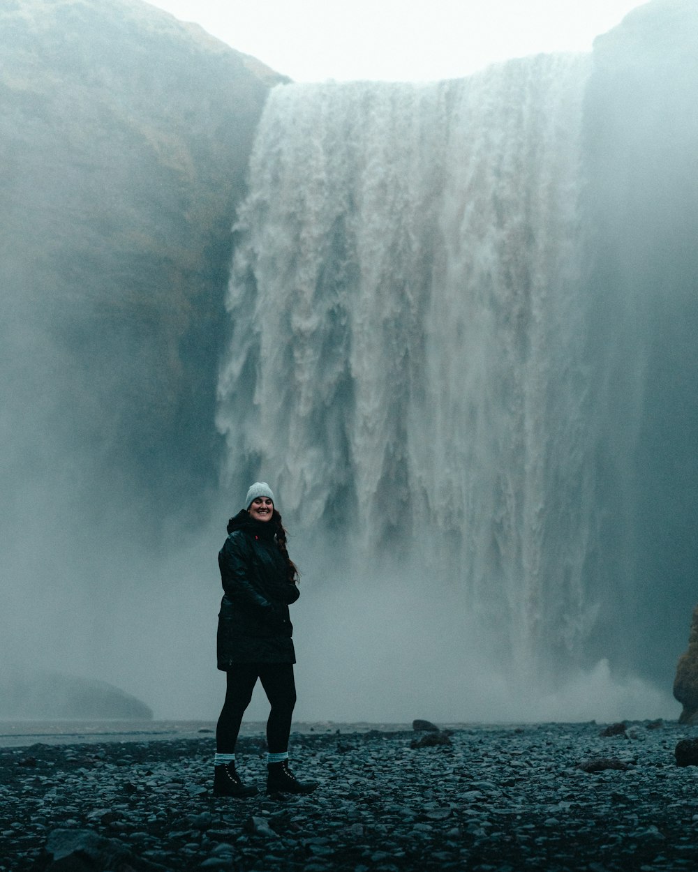 a person standing in front of a waterfall