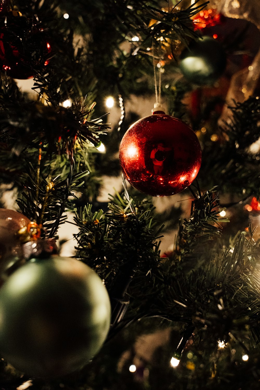 a close up of a christmas tree with ornaments