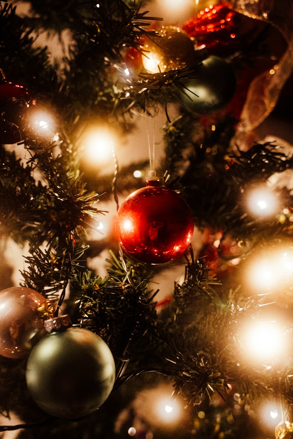 a close up of a christmas tree with ornaments