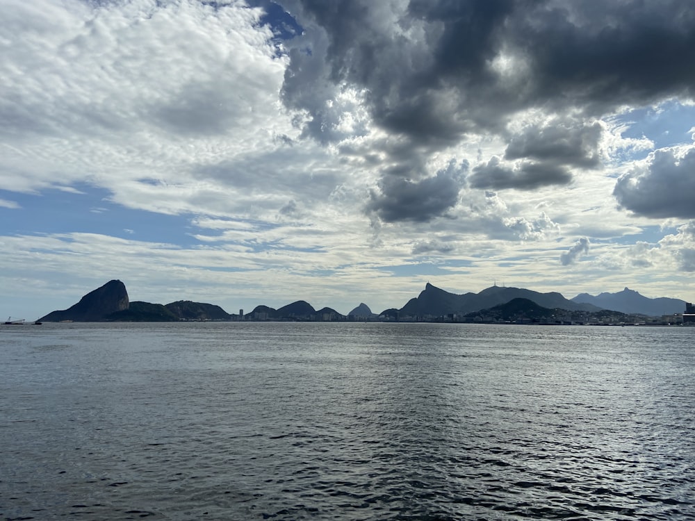 a large body of water with mountains in the background