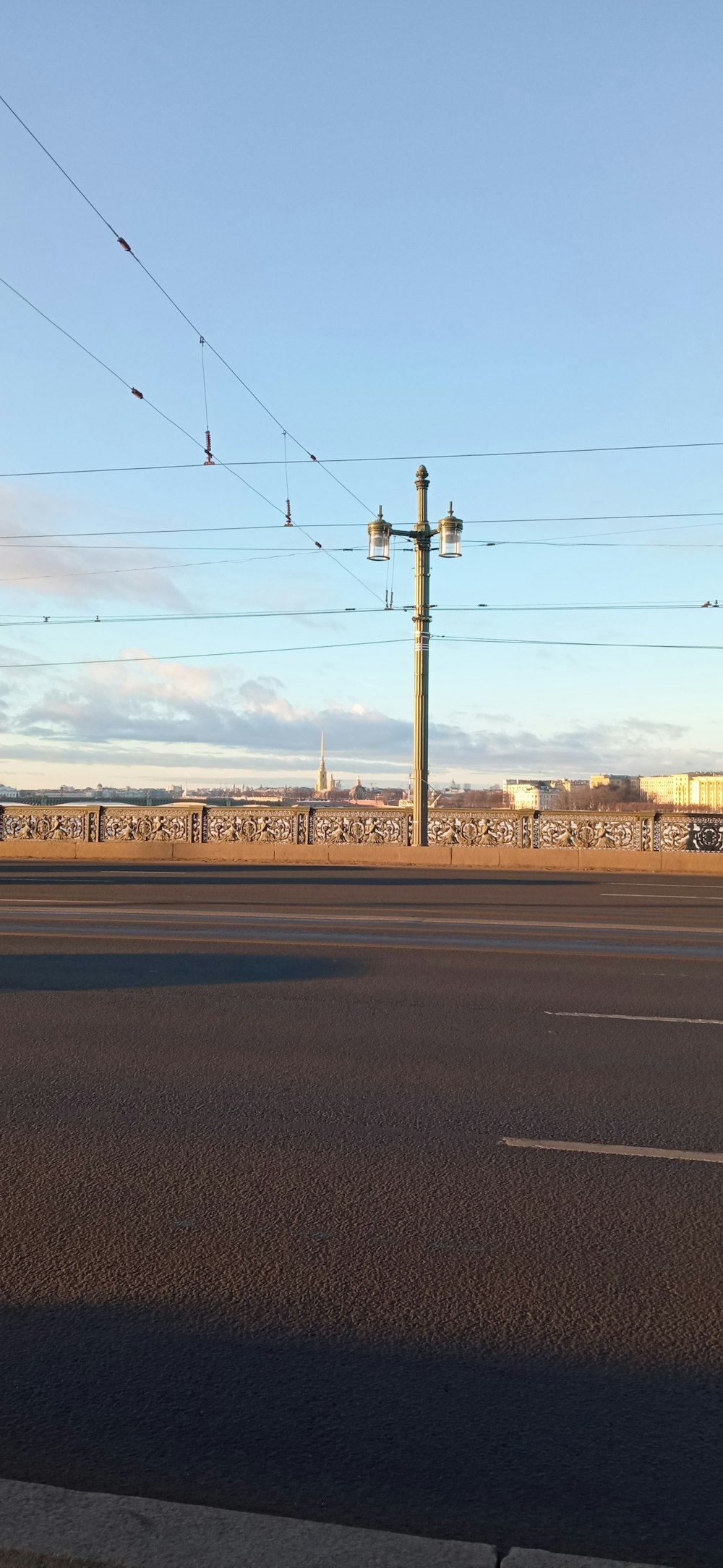 an empty street with power lines above it