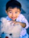 A smiling child hugging a large, fluffy teddy bear in a cozy room.