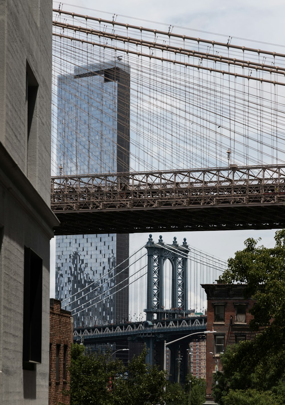 a view of the brooklyn bridge from under a bridge