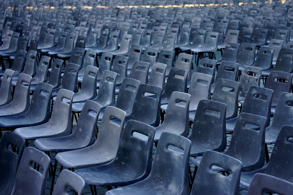 rows of empty plastic chairs in a stadium