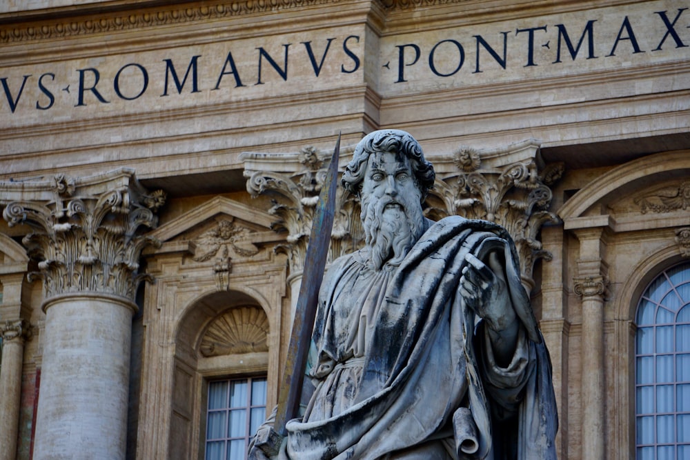 a statue of a man in front of a building