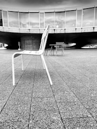 a black and white photo of a chair and table