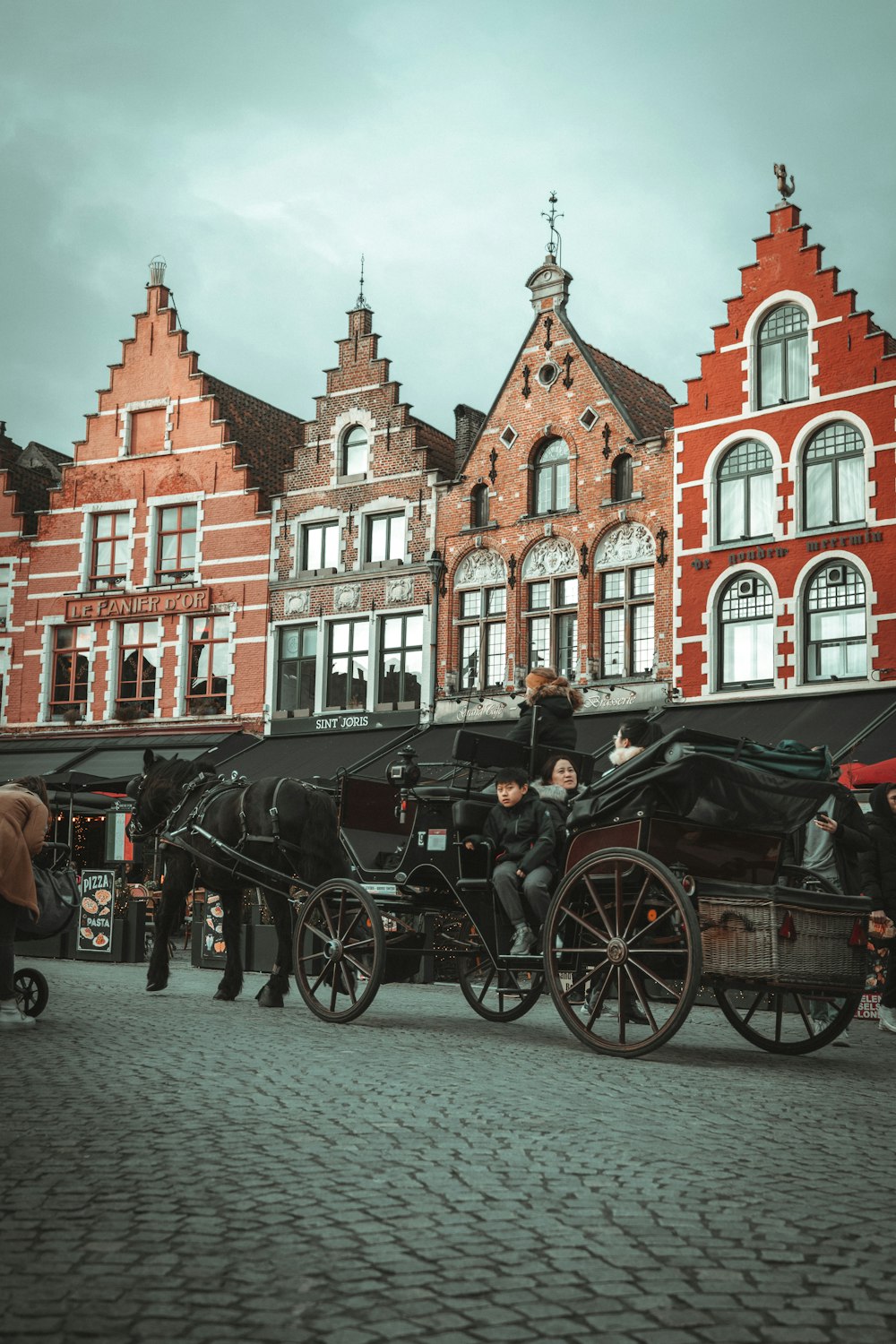 a horse drawn carriage parked in front of a building