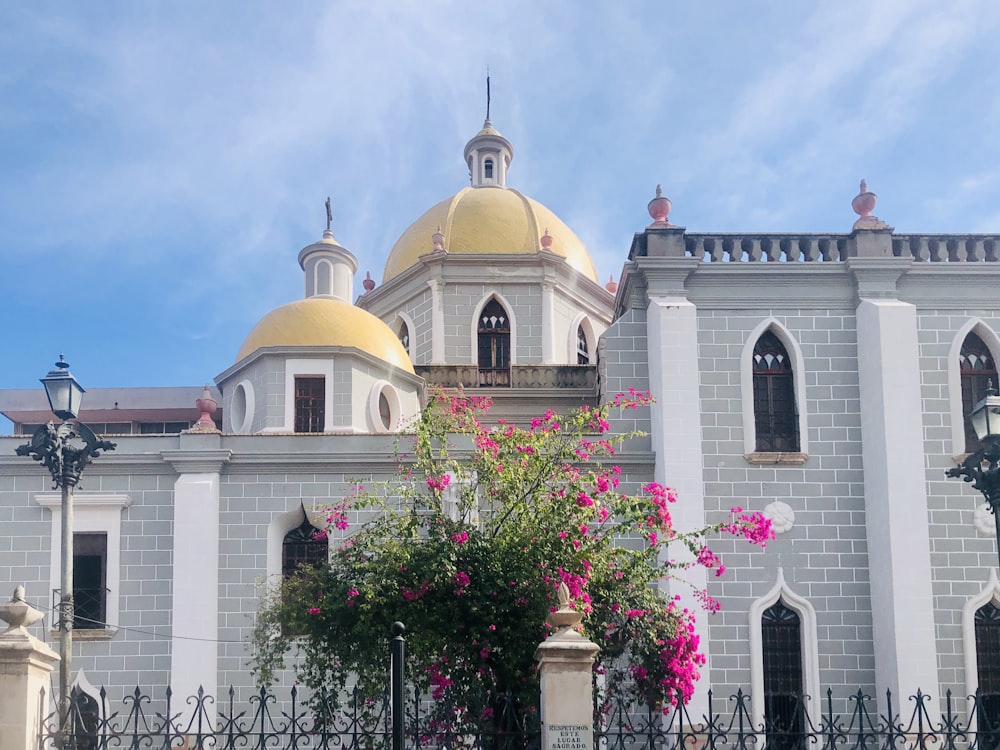 a large white building with a yellow dome