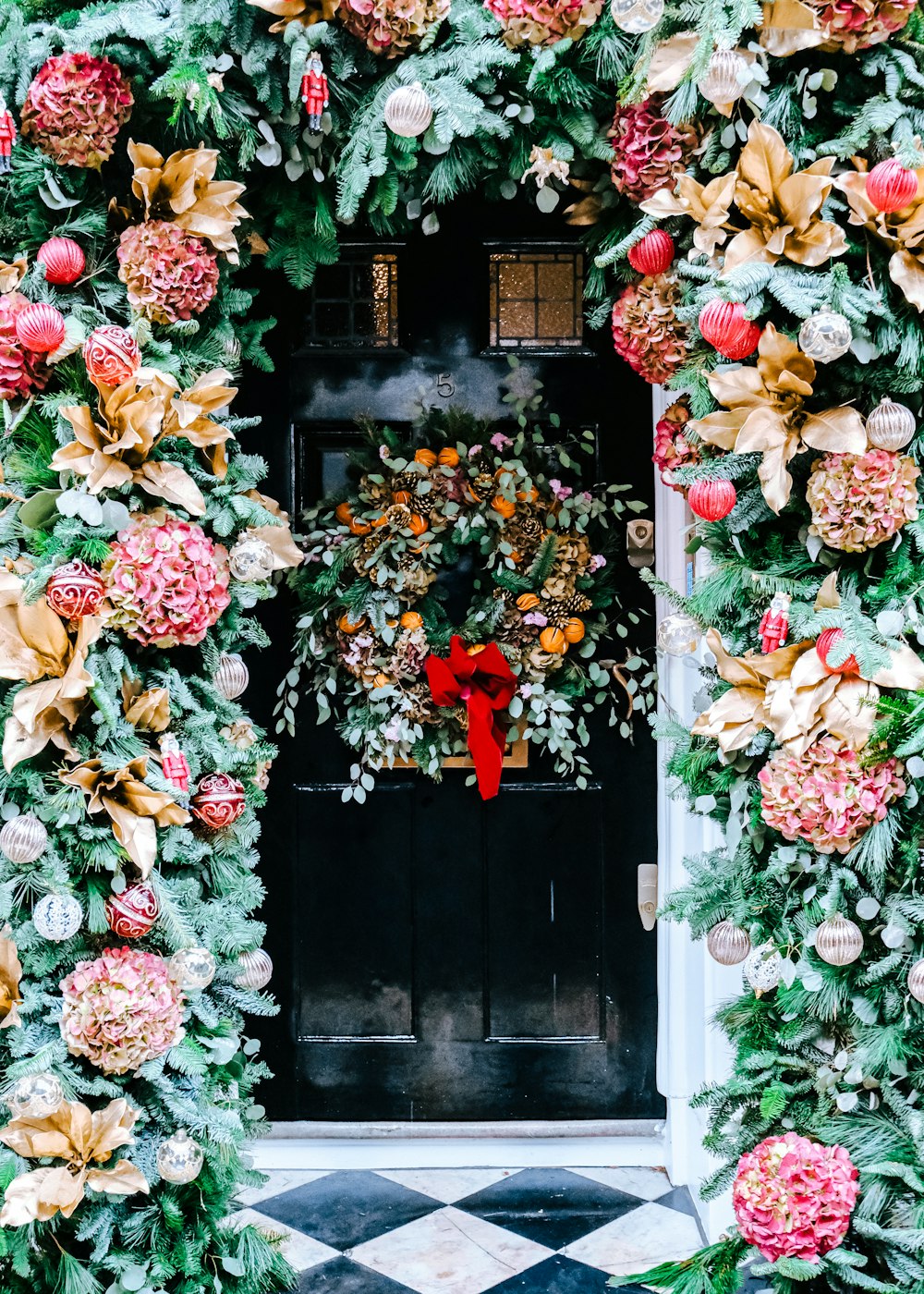 a door decorated with flowers and greenery