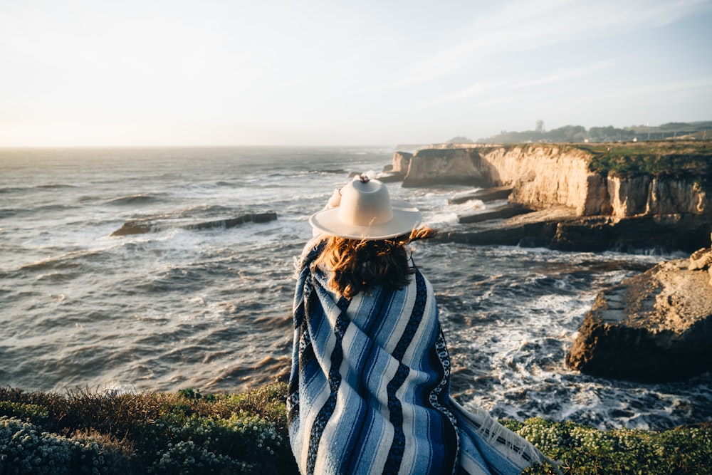 a person standing on a cliff overlooking the ocean