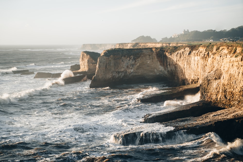 a rocky cliff overlooks a body of water