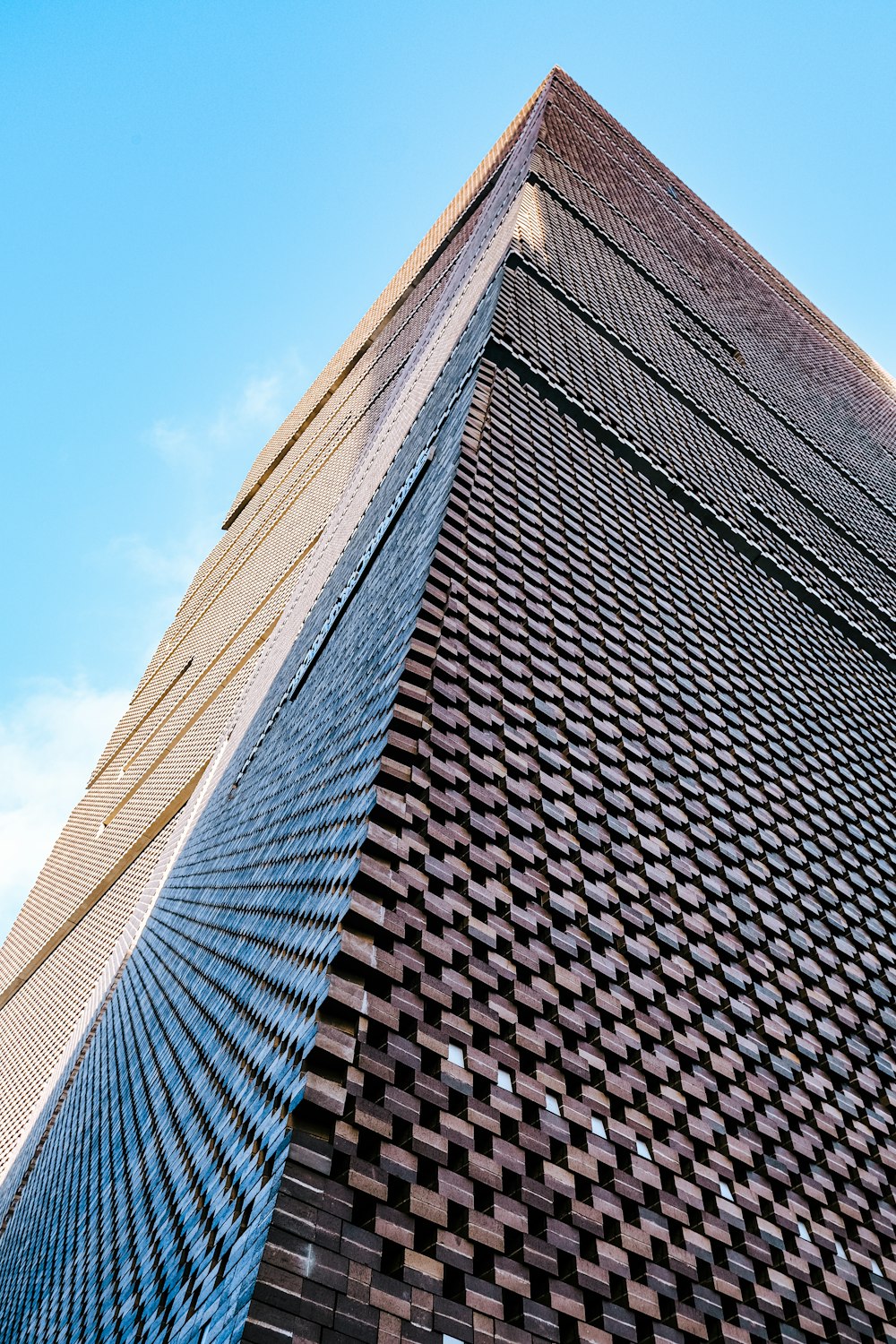 a tall brick building with a sky background