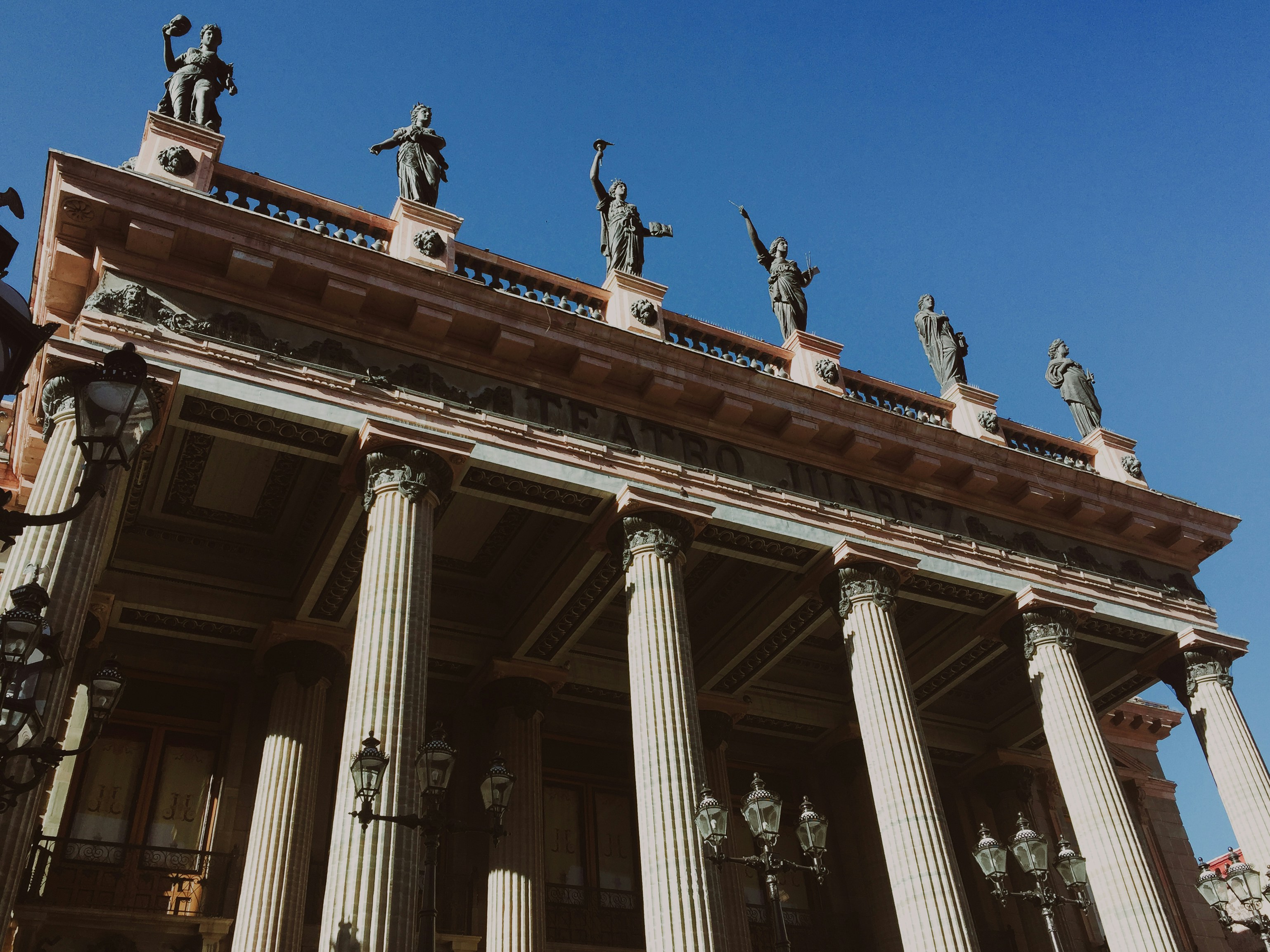 a tall building with many statues on top of it