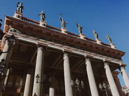 a tall building with many statues on top of it