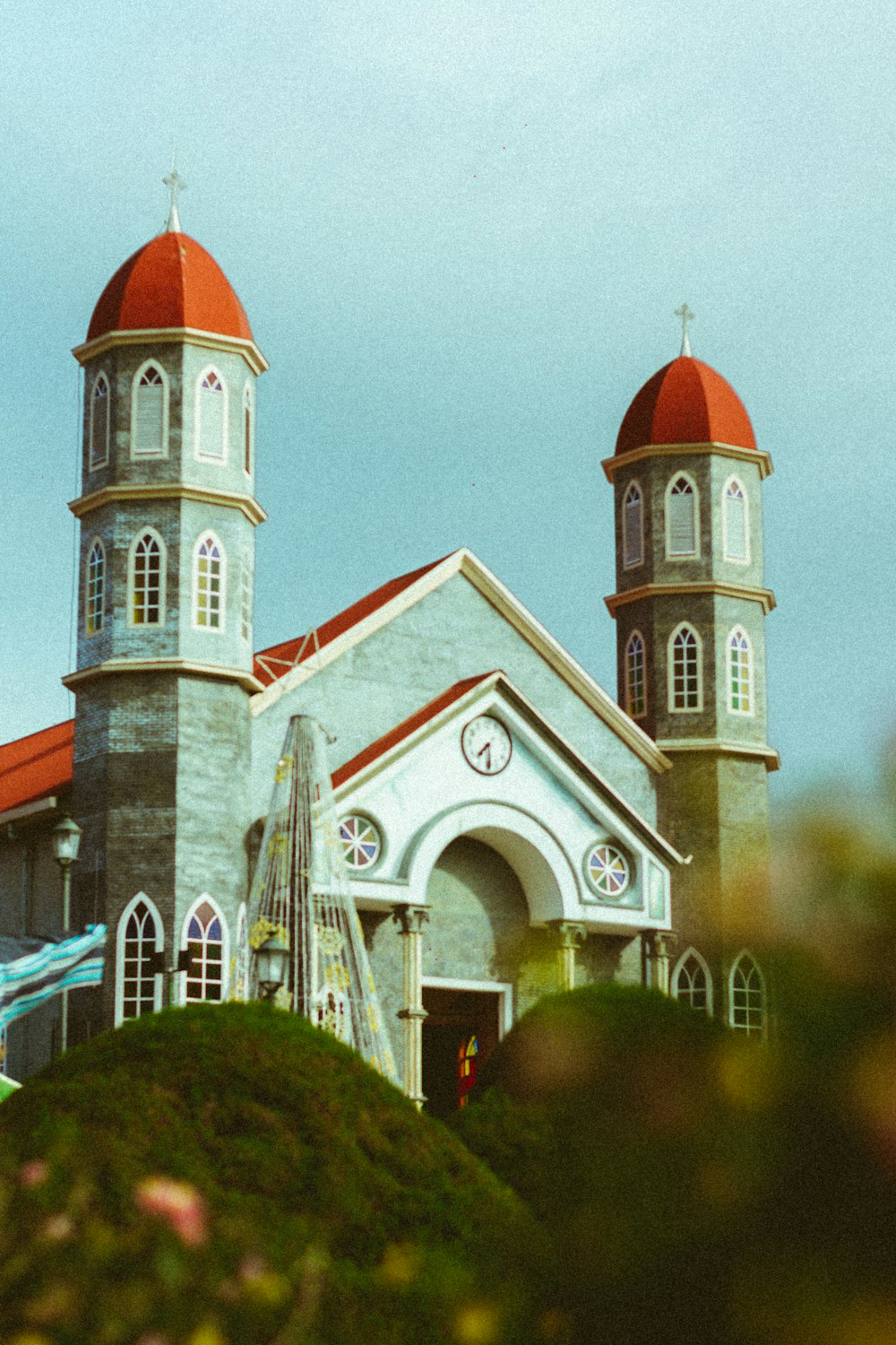 a church with a red roof and two towers