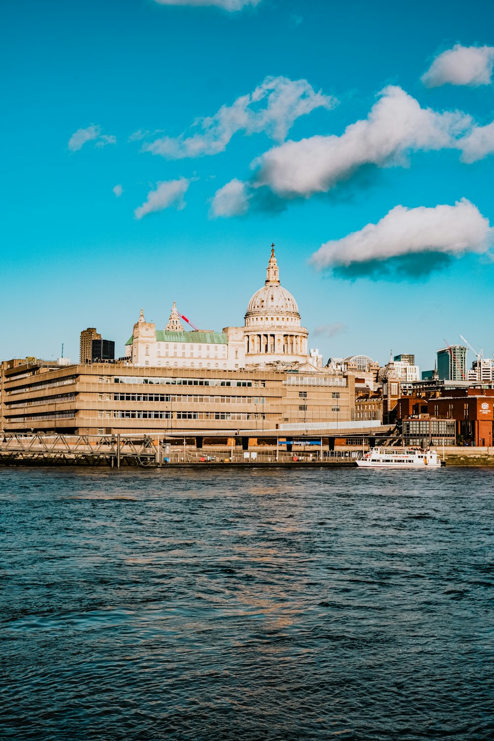 a large building sitting on the side of a river